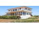 Back exterior showcasing a deck, a walkout basement, multiple windows, and stairs to the yard at 3160 Bella Rosa Pkwy, Longmont, CO 80504