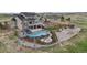 Stunning backyard oasis with a gunite pool, hot tub, slide, and fire pit, perfect for outdoor entertaining at 8750 Red Primrose St, Franktown, CO 80116