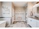 Bright bathroom featuring a standalone soaking tub, vanity, and decor; note the decorative wall art at 8750 Red Primrose St, Franktown, CO 80116