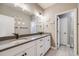 Spacious bathroom featuring a double vanity, gray countertops, and modern fixtures at 8750 Red Primrose St, Franktown, CO 80116