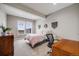 Cozy bedroom with bright windows, a comfortable bed, and a dedicated workspace at 8750 Red Primrose St, Franktown, CO 80116