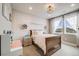 Adorable bedroom with a wooden accent wall, plush carpet, and bright natural light at 8750 Red Primrose St, Franktown, CO 80116
