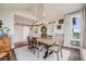 Elegant dining room features a wooden table, seating for six, decorative accents, and modern lighting at 8750 Red Primrose St, Franktown, CO 80116