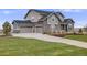 Attractive two-story home with three-car garage, stone accents and well-maintained landscaping at 8750 Red Primrose St, Franktown, CO 80116
