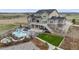 Beautiful home exterior with a backyard pool, hot tub, slide, grassy area, and professional landscaping at 8750 Red Primrose St, Franktown, CO 80116