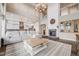 Open concept living room featuring a cozy fireplace, large sofa, stylish decor, and an elegant chandelier at 8750 Red Primrose St, Franktown, CO 80116