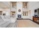Inviting living room boasts a fireplace, soaring ceilings, and a comfortable sofa, perfect for relaxation at 8750 Red Primrose St, Franktown, CO 80116