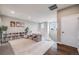 Bright living room featuring a cozy seating area, large bookcase, and access to the staircase at 8750 Red Primrose St, Franktown, CO 80116