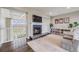 Cozy living room with a fireplace, TV, stylish decor, and scenic views from the upper level at 8750 Red Primrose St, Franktown, CO 80116