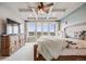Well-lit main bedroom with a coffered ceiling, ceiling fan, balcony access, and scenic outdoor views from the patio doors at 8750 Red Primrose St, Franktown, CO 80116