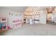 Large playroom featuring a play kitchen, banquet seating, and easy access to stairs at 8750 Red Primrose St, Franktown, CO 80116