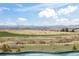 Breathtaking views of open land and distant mountains from the edge of the pool at 8750 Red Primrose St, Franktown, CO 80116