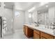 Modern bathroom features a double sink vanity, decorative lighting, and a tiled walk-in shower at 11383 Oakland Dr, Commerce City, CO 80640