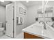 Modern bathroom with double sinks, quartz countertops, and contemporary lighting at 11383 Oakland Dr, Commerce City, CO 80640