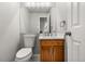 Cozy bathroom with a wood vanity, granite countertop, and ample mirror space at 11383 Oakland Dr, Commerce City, CO 80640