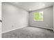 Carpeted bedroom featuring a window providing light and neutral wall colors throughout the space at 11383 Oakland Dr, Commerce City, CO 80640