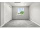 Bright bedroom with plush gray carpeting, white trim, and a window that lets in natural light at 11383 Oakland Dr, Commerce City, CO 80640
