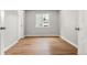 Bright, open bedroom with hardwood floors and natural light from the window at 11383 Oakland Dr, Commerce City, CO 80640