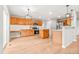 Spacious kitchen with a large island, wooden cabinets, stainless steel appliances, and wood flooring at 11383 Oakland Dr, Commerce City, CO 80640
