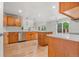 Bright kitchen with wood cabinets, stainless steel appliances, and a large island for entertaining at 11383 Oakland Dr, Commerce City, CO 80640
