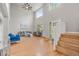 Open living room with tall ceilings, large windows, a ceiling fan, and hardwood floors at 11383 Oakland Dr, Commerce City, CO 80640