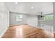 Open-concept loft space featuring hardwood floors, large windows, and a ceiling fan at 11383 Oakland Dr, Commerce City, CO 80640