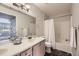 Bathroom features a tub and shower combo, white tiling, and a single vanity at 3727 Cactus Creek Ct # 204, Highlands Ranch, CO 80126
