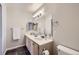Bathroom with double sinks, white counter, slate-look tile, and a large mirror at 3727 Cactus Creek Ct # 204, Highlands Ranch, CO 80126