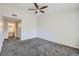 Bedroom features gray carpet, ceiling fan, and doorway to bathroom for a seamless and comfortable flow at 3727 Cactus Creek Ct # 204, Highlands Ranch, CO 80126