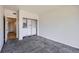 Bright bedroom with gray carpet, walk-in closet with built-in shelving, and a connecting door at 3727 Cactus Creek Ct # 204, Highlands Ranch, CO 80126