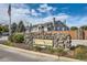 Canyon Ranch community sign constructed of stone and landscaped with shrubs against a blue sky with townhomes in the background at 3727 Cactus Creek Ct # 204, Highlands Ranch, CO 80126