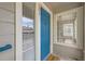Close-up of unit front entrance, featuring stylish blue door with welcome mat at 3727 Cactus Creek Ct # 204, Highlands Ranch, CO 80126