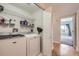 Laundry room with white washer and dryer and shelving at 3727 Cactus Creek Ct # 204, Highlands Ranch, CO 80126