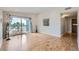 Bright living room with wood floors, leads to balcony with outdoor seating at 3727 Cactus Creek Ct # 204, Highlands Ranch, CO 80126