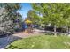 Community playground and play structure, with well-maintained lawn, trees, and a fenced perimeter at 3727 Cactus Creek Ct # 204, Highlands Ranch, CO 80126