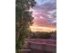 Beautiful sunset view from the property, featuring a brick wall and lush greenery at 3727 Cactus Creek Ct # 204, Highlands Ranch, CO 80126