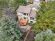 Bird's eye view of the house showcasing the backyard, wooden deck, and mature trees at 5814 Cole Way, Arvada, CO 80004