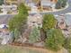 Aerial view of the house with a large, fenced backyard, surrounded by mature trees at 5814 Cole Way, Arvada, CO 80004