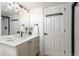 Modern bathroom with a sleek vanity, updated fixtures, and a glass-enclosed shower at 5814 Cole Way, Arvada, CO 80004