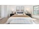 Bright bedroom featuring a king bed, bedside tables, stylish decor, and a large window at 5814 Cole Way, Arvada, CO 80004