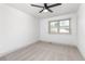 Spare bedroom featuring a ceiling fan, window, and neutral carpet at 5814 Cole Way, Arvada, CO 80004
