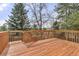 Spacious wooden deck surrounded by lush greenery, perfect for outdoor entertaining at 5814 Cole Way, Arvada, CO 80004