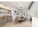 A dining area with sleek cabinets, modern lighting, and a bay window for ample natural light at 5814 Cole Way, Arvada, CO 80004
