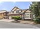 Two-story home featuring a well-maintained lawn, brick accents, bay window, and a spacious three-car garage at 5814 Cole Way, Arvada, CO 80004