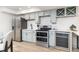 Modern kitchen featuring stainless steel appliances, gray cabinetry, and ample counter space at 5814 Cole Way, Arvada, CO 80004