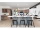 Bright kitchen with a large island with seating and modern appliances and fixtures at 5814 Cole Way, Arvada, CO 80004
