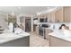 A modern kitchen featuring stone countertops, stainless steel appliances, and ample cabinet space at 5814 Cole Way, Arvada, CO 80004