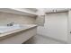 Bright laundry room features tile floors and backsplash, plus a sink and storage at 5814 Cole Way, Arvada, CO 80004