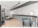 Sitting area featuring a desk, beams and an arm chair, all with wood flooring at 5814 Cole Way, Arvada, CO 80004