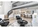 Open-concept living room with high ceilings, hardwood floors, and modern furnishings showcases an open design at 5814 Cole Way, Arvada, CO 80004